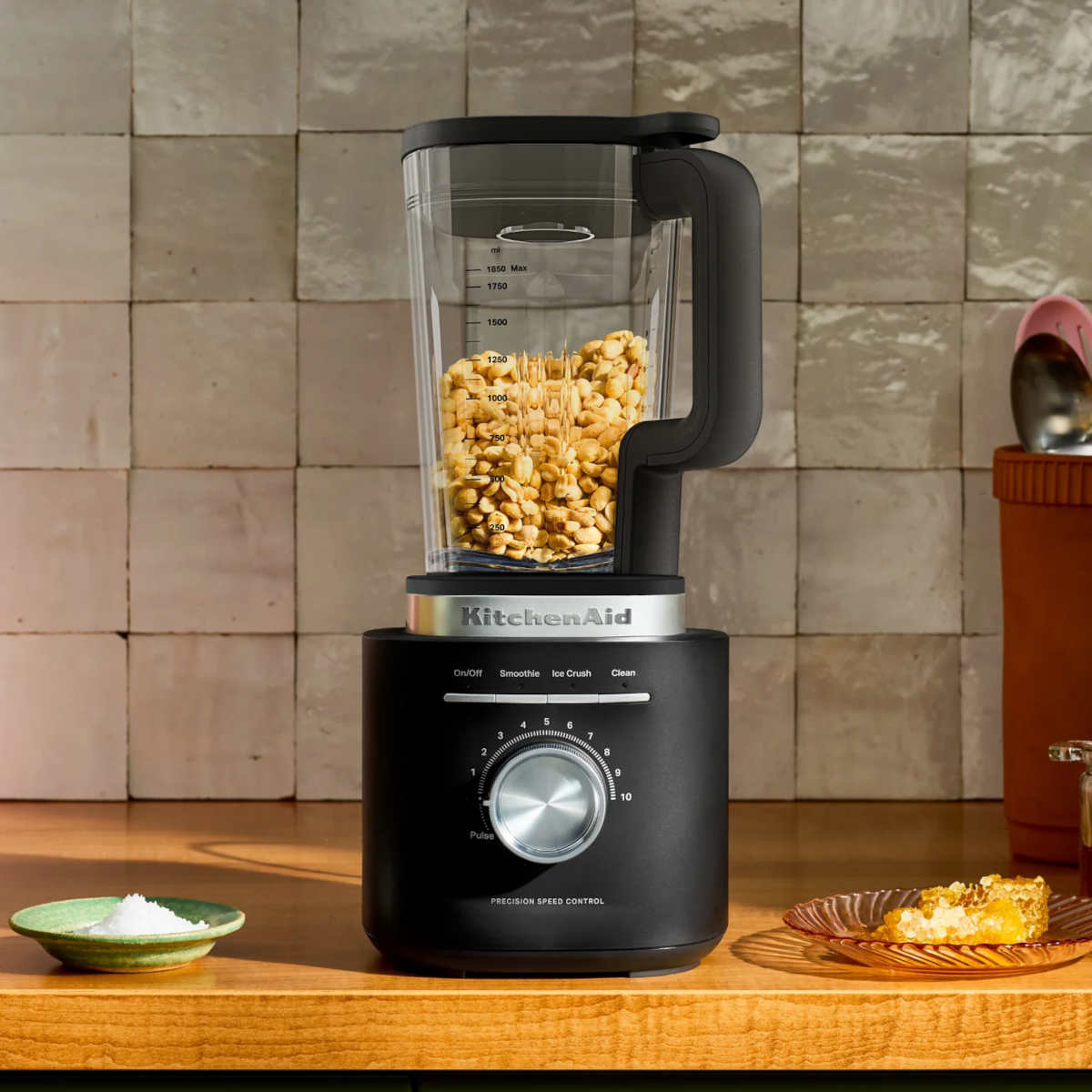 KitchenAid Pure Power Blender in Matte Black with glass jar filled with roasted peanuts, ready for homemade nut butter.