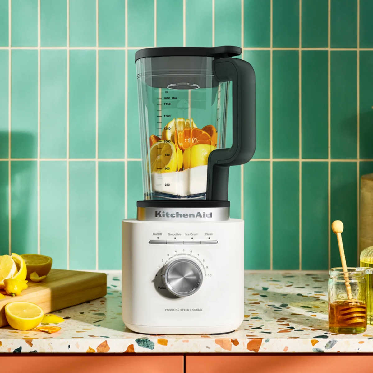 KitchenAid Pure Power Blender with glass jar filled with fresh citrus ingredients on a kitchen countertop.