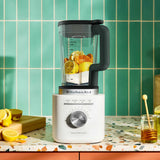 KitchenAid Pure Power Blender with glass jar filled with fresh citrus ingredients on a kitchen countertop.