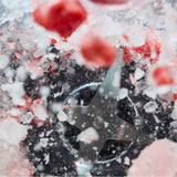 Close-up of the KitchenAid Pure Power Blender stainless steel blade crushing ice and frozen strawberries.
