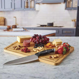 Farberware SnackleBox with Bamboo Board 30 x 40cm - Wooden board with knife and assorted food on a kitchen counter