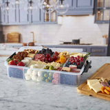 Farberware SnackleBox with Bamboo Board 30 x 40cm - Rectangular platter with assorted meats, cheeses, fruits, and crackers on a kitchen counter.