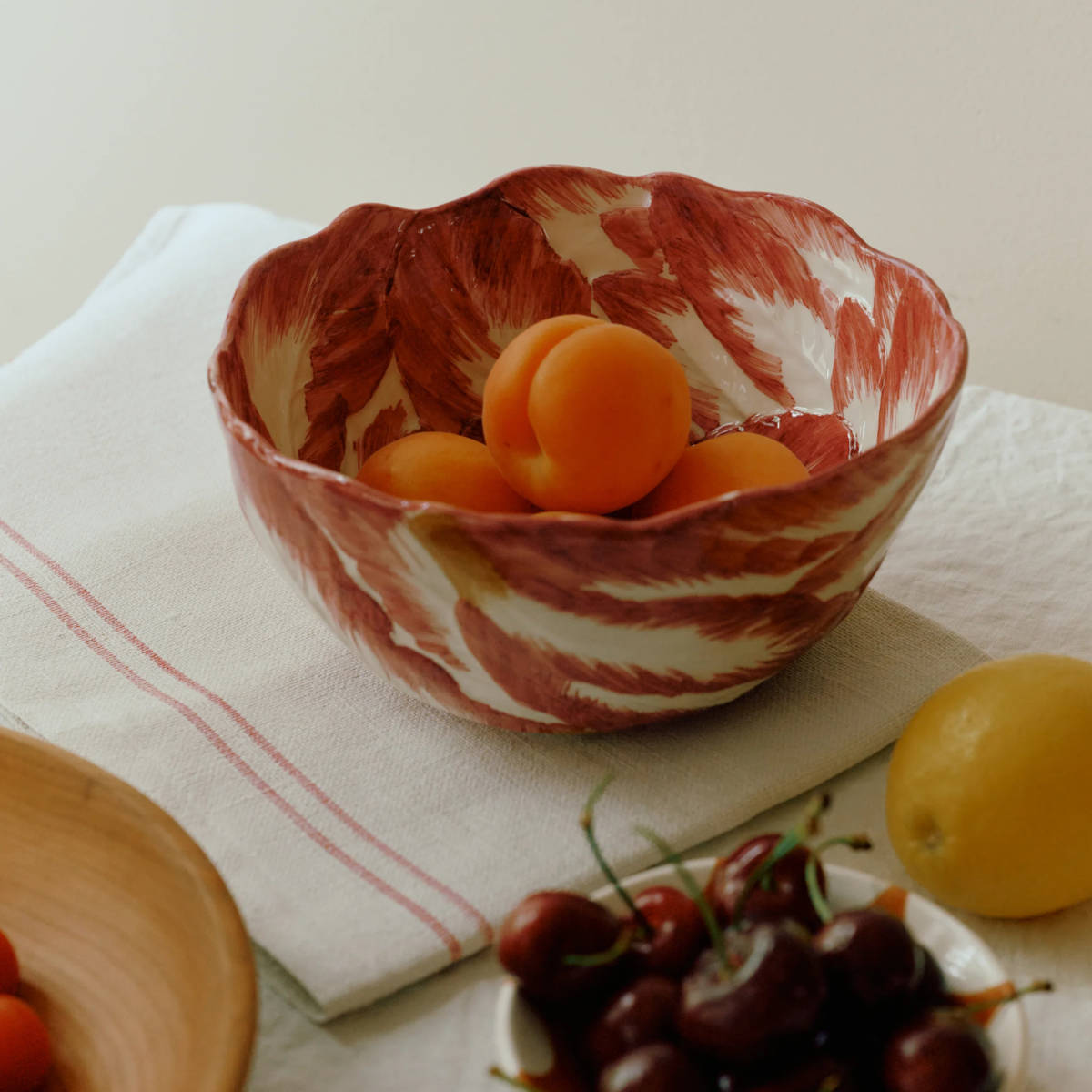 La Ceramica Radicchio Round Bowl Medium Red 26x11cm – lifestyle shot with fruit inside