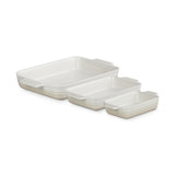 Angled view of Le Creuset Heritage Rectangular Dish Meringue Set of 3 nested on white