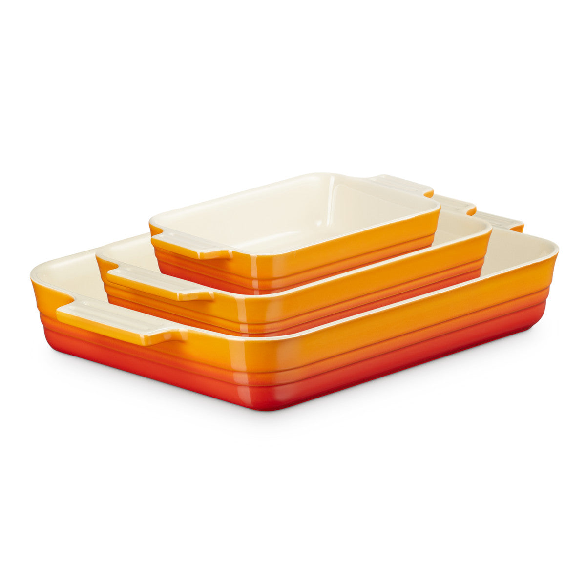 Angled view of Le Creuset Rectangular Dish Volcanic Set of 3 stacked together on white surface