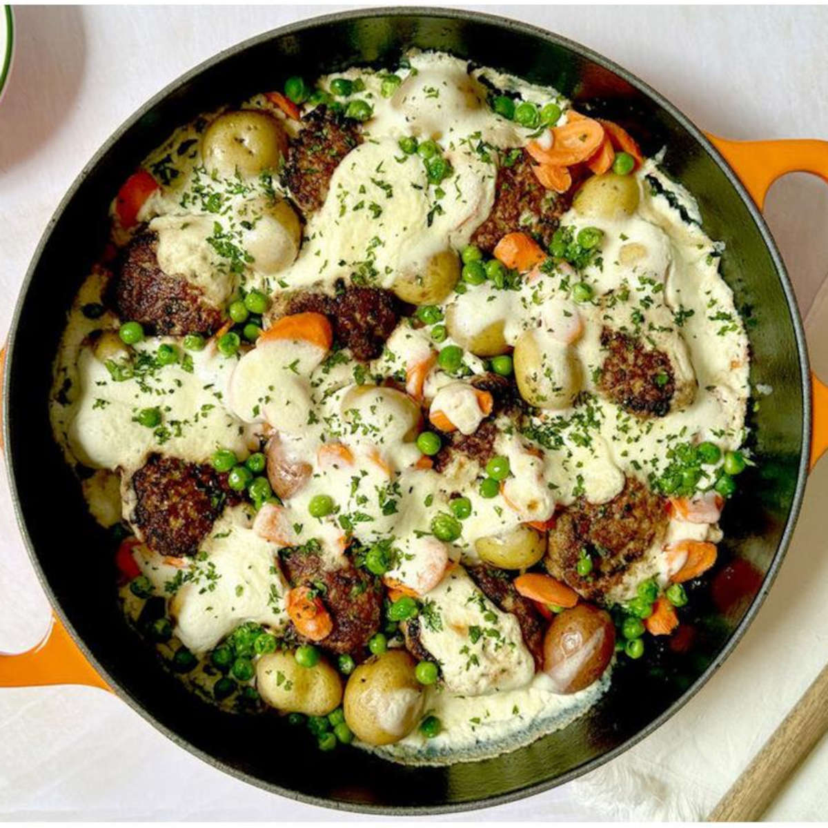 Le Creuset Signature Everyday Pan filled with baked vegetables and creamy sauce