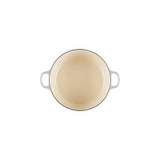 Top-down view of open Le Creuset Shallot casserole showing cream enamel interior.