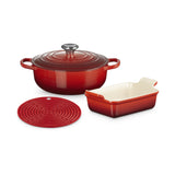 Le Creuset Starter Set Cerise 3 Piece including round casserole, rectangular baking dish, and silicone trivet in deep red color on white background