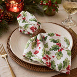 Christmas-themed table setting with holly leaf napkins on a plate | Minimax