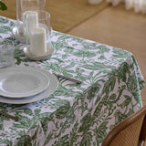 Madras Link Samara Tablecloth Green 150 x 230cm  – dining table styled with green leafy patterned tablecloth and tableware
