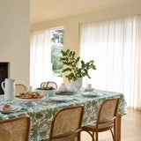 Madras Link Samara Tablecloth Green 150 x 230cm – green leafy patterned tablecloth on dining table with white dinnerware