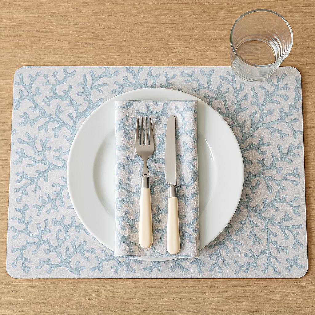 Madras Link Hayman Rectangle Placemat Coral Set of 4 - Dinner setting with white plate, fork, knife, and napkin on a patterned placemat.