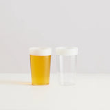Maison Balzac Ceres Beer Glasses 375ml (Set of 2) – one filled with beer, one empty on white surface