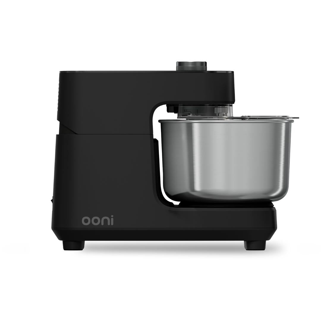 Side profile of the Ooni Halo Core Spiral Mixer in Foundry Black with stainless steel mixing bowl attached.