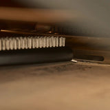 Ooni Pizza Oven Brush Short, angled view of compact pizza oven brush with wooden handle and metal scraper