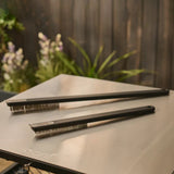 Ooni Pizza Oven Brush Short, angled view of compact pizza oven brush with wooden handle and metal scraper