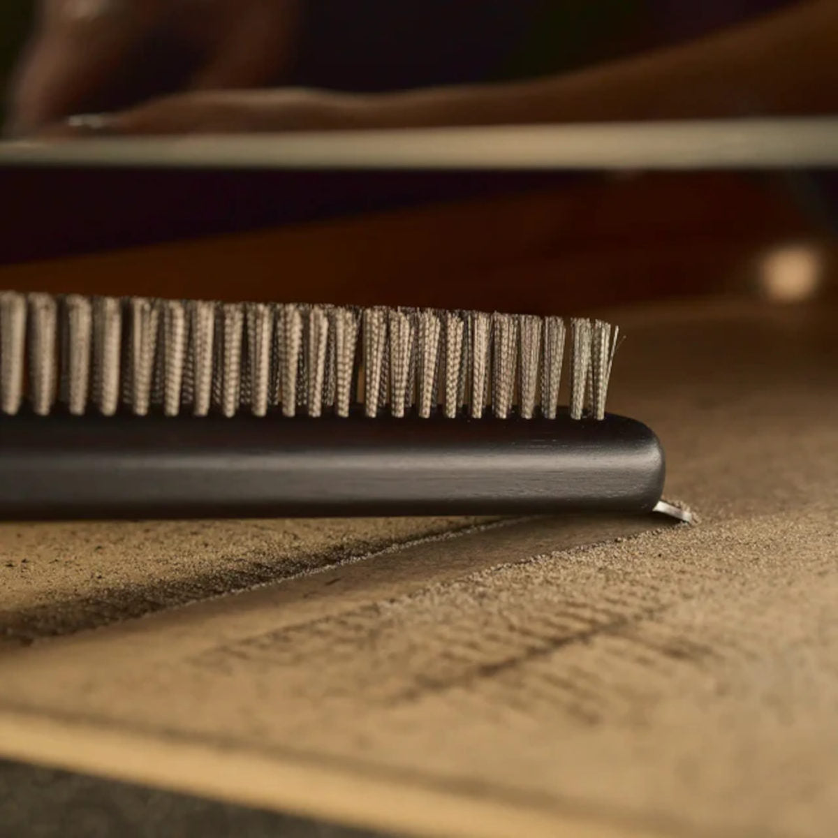 Ooni Pizza Oven Brush Short, angled view of compact pizza oven brush with wooden handle and metal scraper