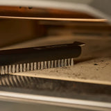 Ooni Pizza Oven Brush Short, angled view of compact pizza oven brush with wooden handle and metal scraper