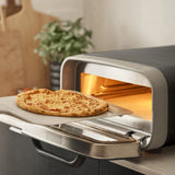Ooni Volt 2 Pizza Oven Charcoal – countertop view with pizza baking at high heat