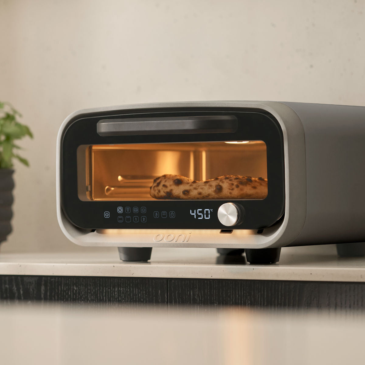 Ooni Volt 2 Pizza Oven Charcoal – kitchen view baking sesame bagels inside oven