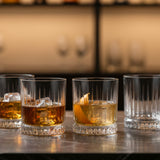 Pasabahce Elysia 355ml DOF tumblers serving whisky and cocktails over ice on a bar countertop, set of four.
