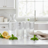 Pasabahce Elysia 445ml long drink glasses displayed with a glass water carafe, fresh lemon and mint on a bright kitchen countertop, set of four.