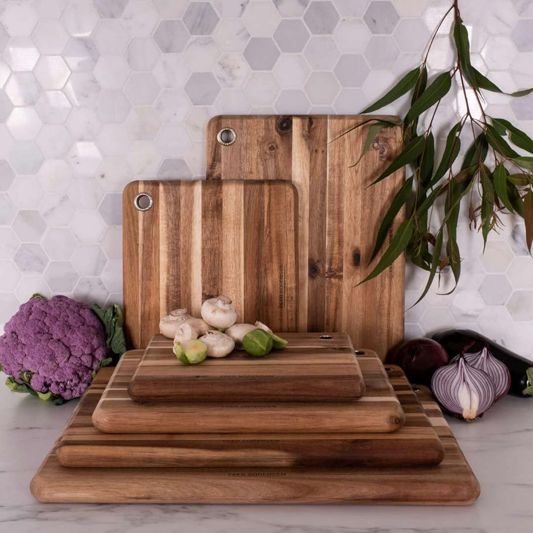 Peer Sorensen wooden cutting boards stacked with vegetables, acacia chopping boards in kitchen setting