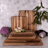 Peer Sorensen wooden cutting boards stacked with vegetables, acacia chopping boards in kitchen setting