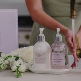 A luxurious sink-side setup featuring patchouli & bergamot hand wash and body cream
