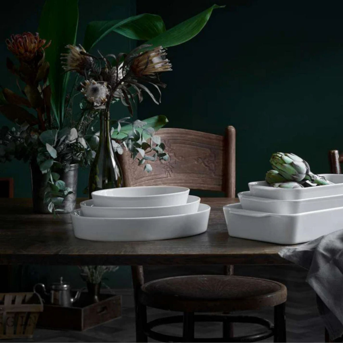 Pillivuyt Deep Oval Baker 36x26cm – lifestyle display on wooden table with florals and artichokes