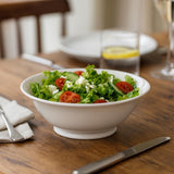 Pillivuyt Ordinaire Salad Bowl 22cm - filled with salad on a dining table with cutlery and a glass