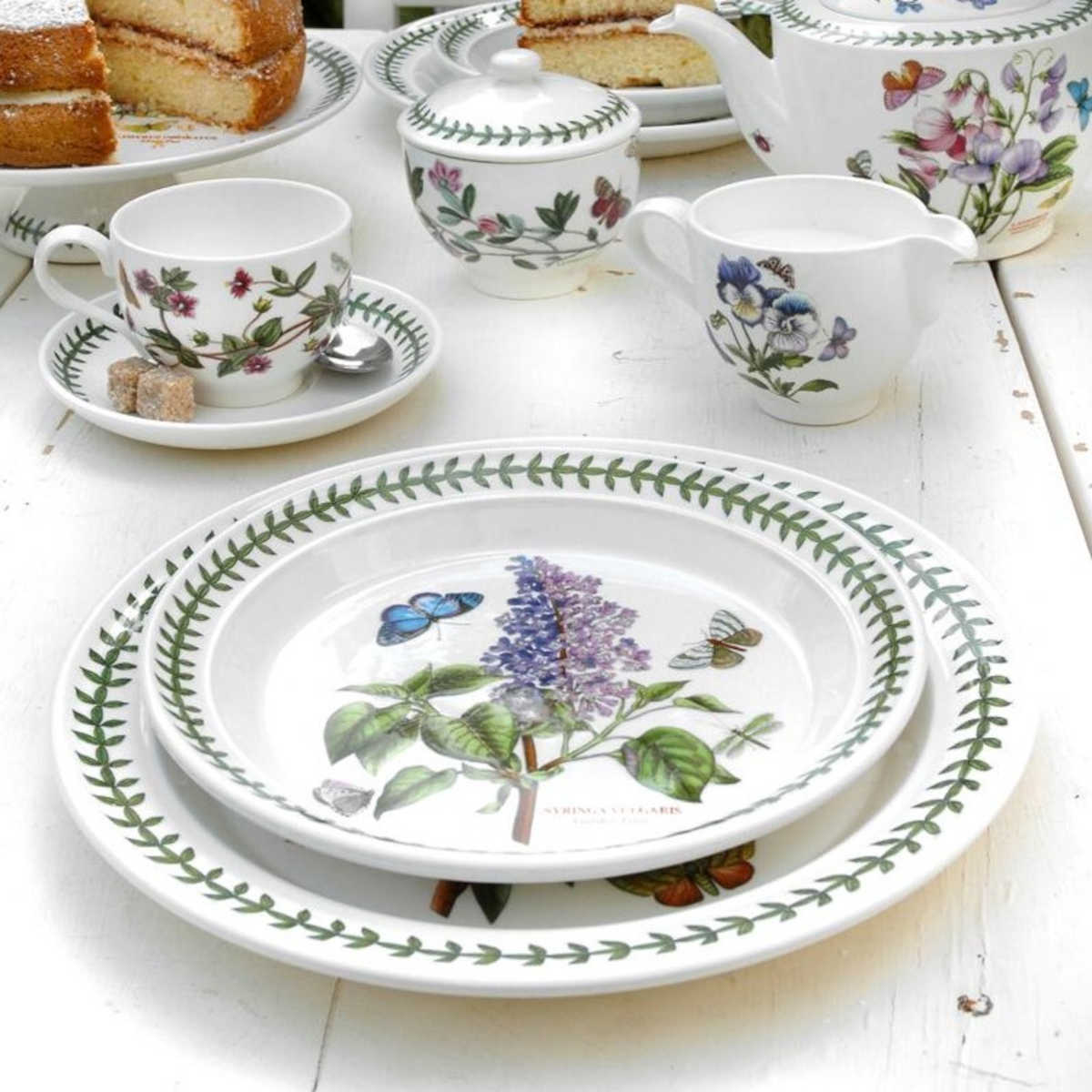 Portmeirion Botanic Garden Entrée Plate 20cm set featuring assorted floral patterns with butterflies and green leaf border, made from fine earthenware