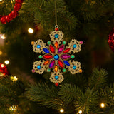 RAZ Jeweled Snowflake Hanging Decoration Multicolour 14cm - Colorful snowflake ornament on a Christmas tree with blurred lights in the background