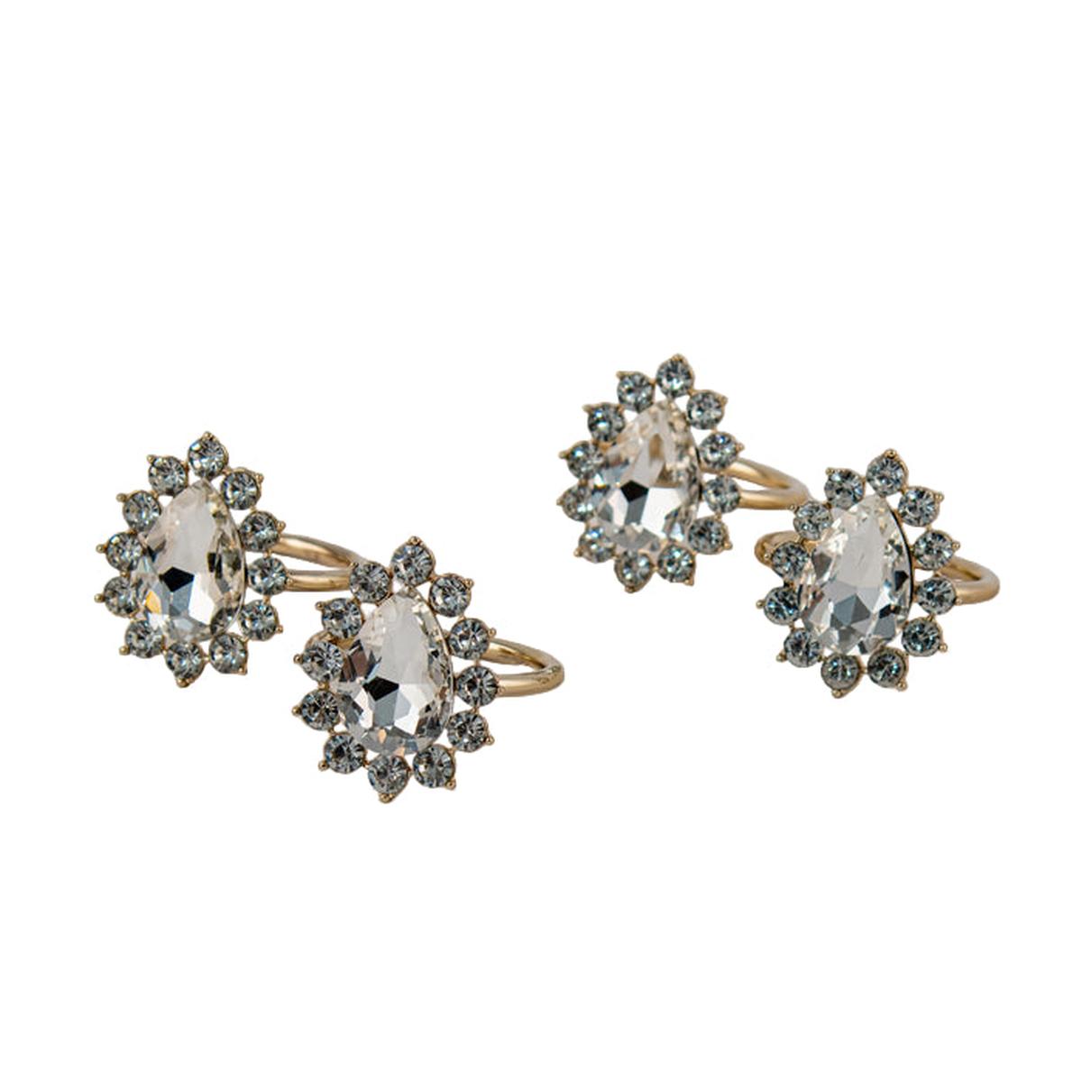 Set of gold napkin rings with gemstone accents on a light gray background