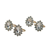 Set of gold napkin rings with gemstone accents on a light gray background