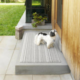 Chilewich Utility Mat Skinny Stripe Birch 61x91cm | Minimax - in a patio with a dog