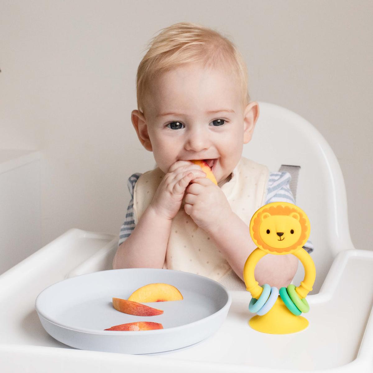 Tiger Tribe High Chair Buddy - Silicone Lion | Minimax - with a kid eating apple