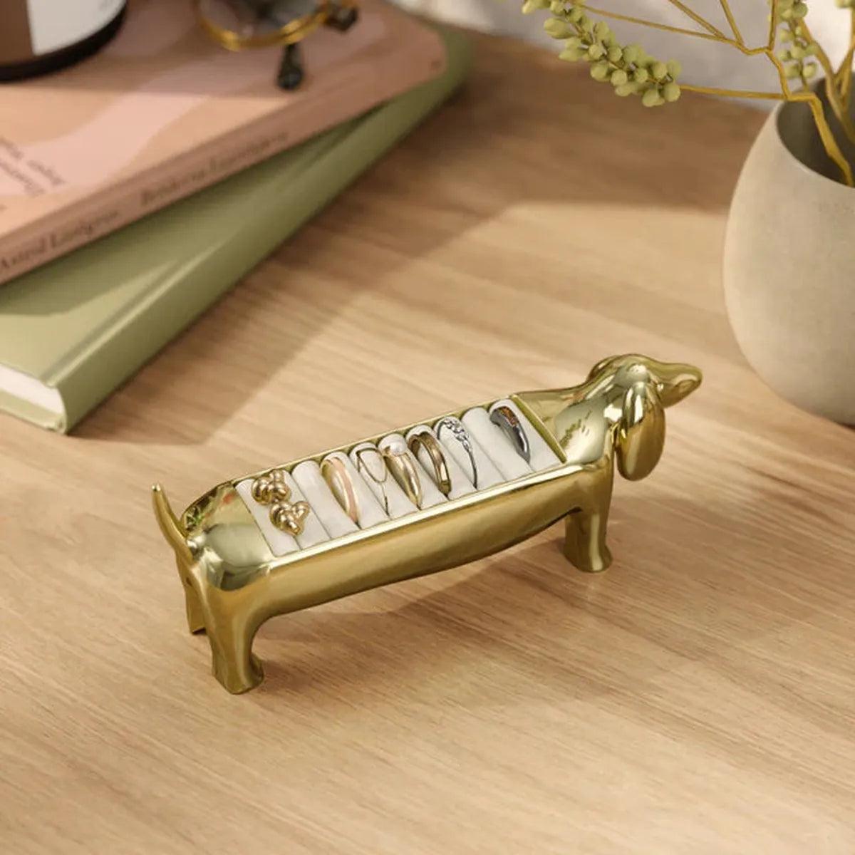 Umbra Dachsie Ring Holder Brass shaped like a dachshund with ridged tray along its back