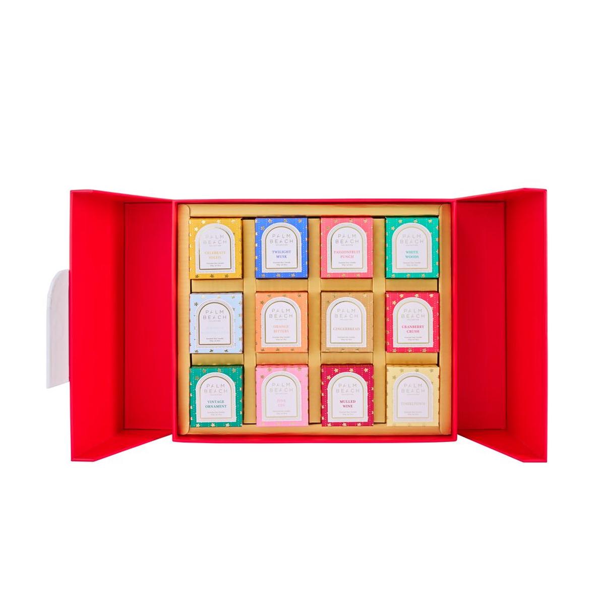 Palm Beach Collection Candle Advent Calendar – Christmas countdown set with 12 assorted candles in a festive red box.