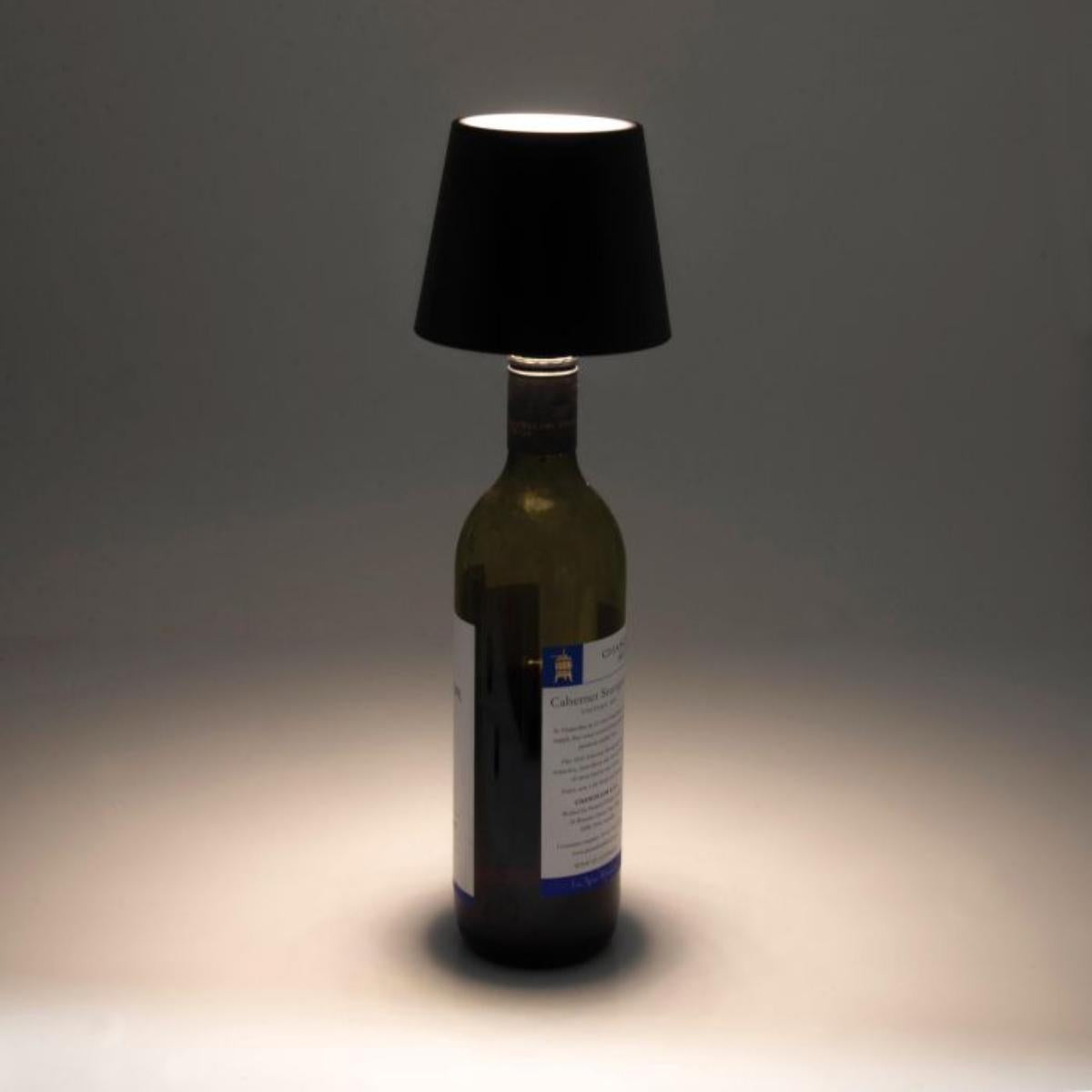 Maverick Rechargeable Bottle Lamp Black with black shade displayed on a blue ribbed bottle