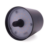 Maverick Rechargeable Bottle Lamp Black with black shade displayed on a blue ribbed bottle