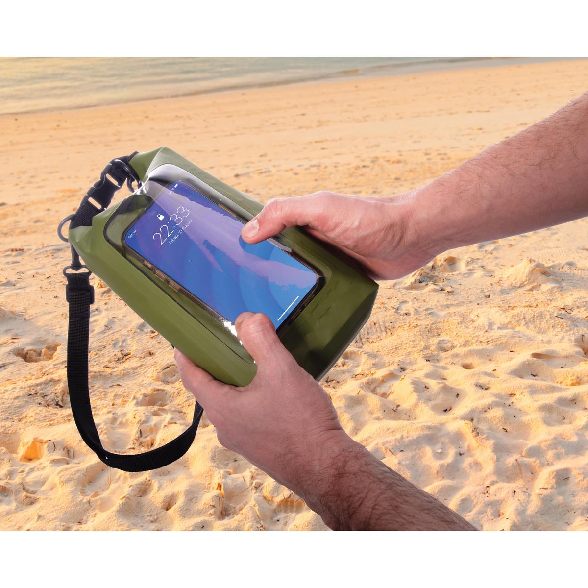 Maverick Dry Bag Green 2 Litres - with a hand holding in a beach| Minimax