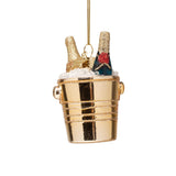 Gold bucket ornament with a bottle and ice cubes on a white background